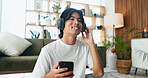 Man, phone and smile with headphones on floor in home with sound, relax and listen to music in lounge. Person, smartphone and happy with streaming service, subscription or mobile app at apartment