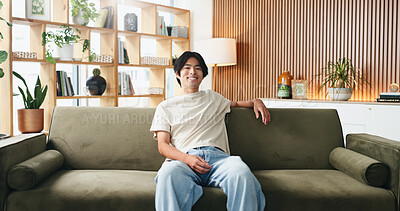 Buy stock photo Portrait, relax and smile of Asian man on sofa in home living room for weekend break as student. Comfortable, confidence and me time with college or university pupil on apartment couch in Japan