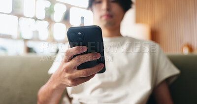 Buy stock photo Text, scroll and hands in house with phone, internet search and communication on online platform. Browse, digital and Asian man in home with tech, social media update and message on virtual app.