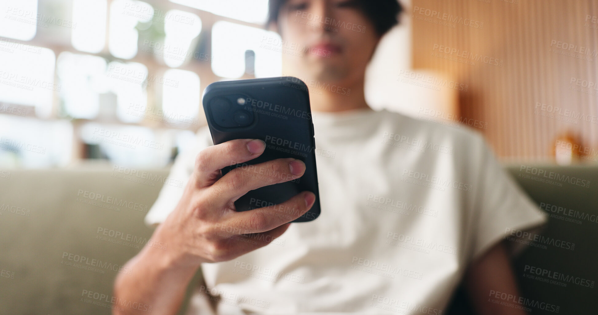 Buy stock photo Text, scroll and hands in house with phone, internet search and communication on online platform. Browse, digital and Asian man in home with tech, social media update and message on virtual app.