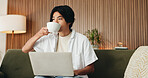 Coffee, laptop and man on sofa in house with online application for university scholarship. Education, relax and Asian male student drinking warm beverage with computer for studying in living room.
