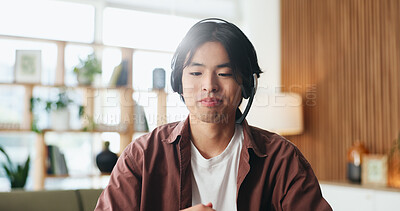 Buy stock photo Man, consultant or remote work with headset in home for customer service, CRM or online advice. Male person, asian agent or freelancer with mic for virtual assistance, help or web support in house