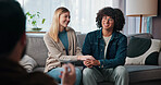 Psychologist, happy couple and holding hands in consultation for love, support or reconciliation. Man, woman and counseling with therapist for advice, save marriage or help in office with solution