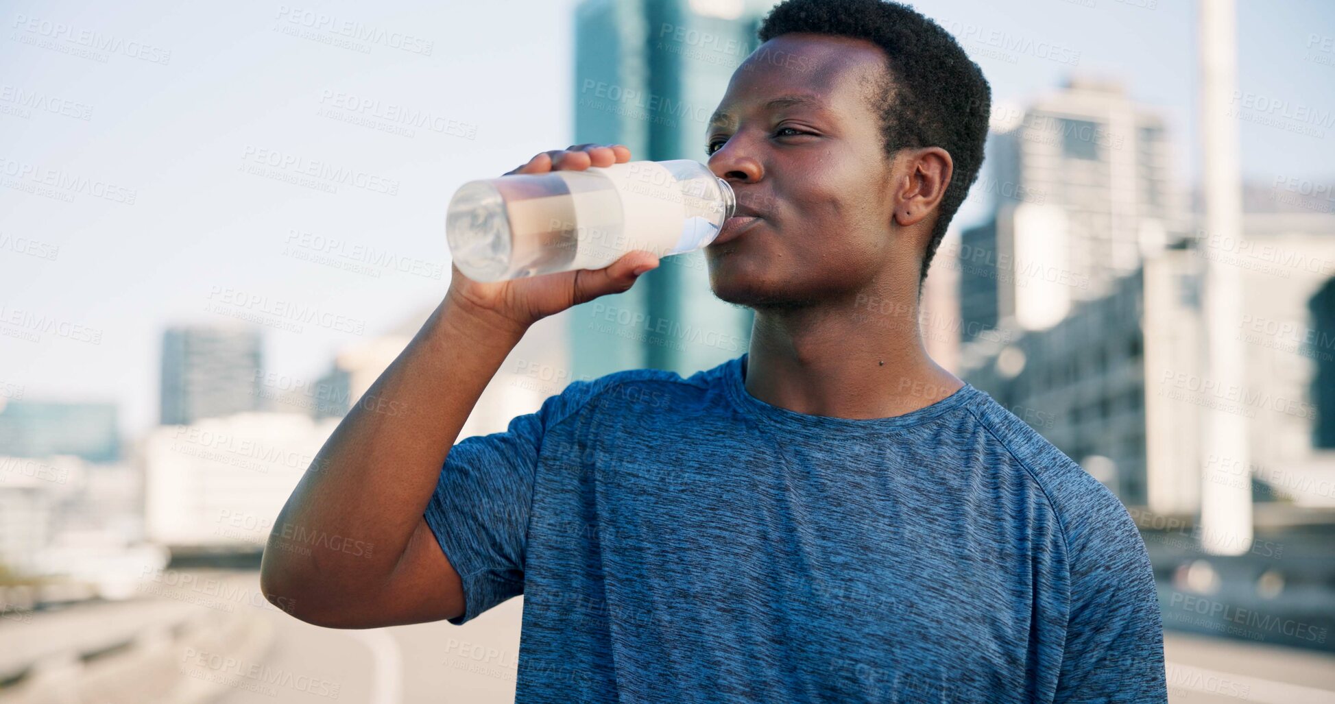 Buy stock photo Black man, fitness and drinking with water in city for hydration, sustainability or thirst. Active, male person or runner with mineral liquid or beverage for break, rest or recovery in an urban town