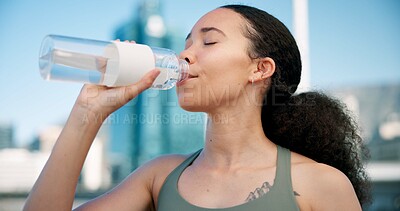 Buy stock photo Woman, fitness and drinking with water in city for hydration, sustainability or thirst. Active, female person or runner with mineral liquid or beverage for break, rest or recovery in an urban town