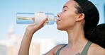 Woman, fitness and drinking with water for hydration, outdoor sustainability or thirst. Active, female person or runner with mineral liquid or beverage for break, rest or recovery in an urban town