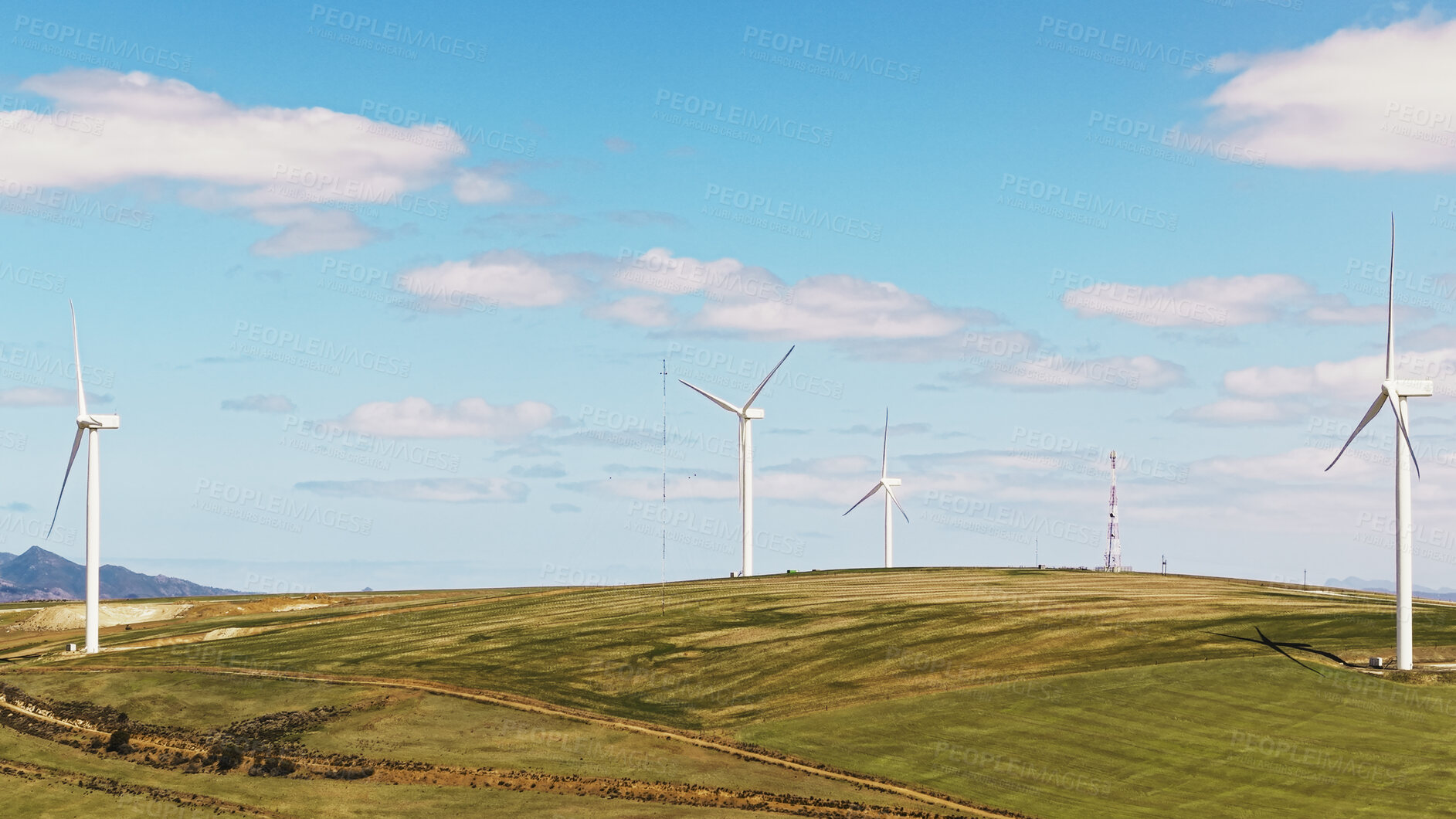 Buy stock photo Blue sky, nature and wind turbines outdoor by grass for renewable energy, sustainable or eco friendly. Field, clouds and windmills for natural resource with economic development in countryside.
