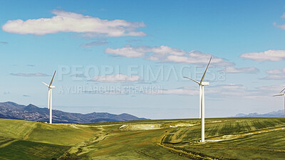 Buy stock photo Blue sky, eco friendly and wind turbine outdoor by grass for renewable energy, sustainable or nature. Field, clouds and windmill for natural resource with economic development in countryside.