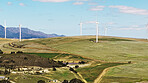 Blue sky, farm and wind turbine outdoor by grass for renewable energy, sustainable or eco friendly. Nature, clouds and windmill for natural resource with economic development in field in countryside.