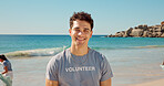 Happy, man and portrait of volunteer on beach with confidence for social responsibility. Smile, NGO and male charity worker by ocean for community service with earth day project by sea conservation.