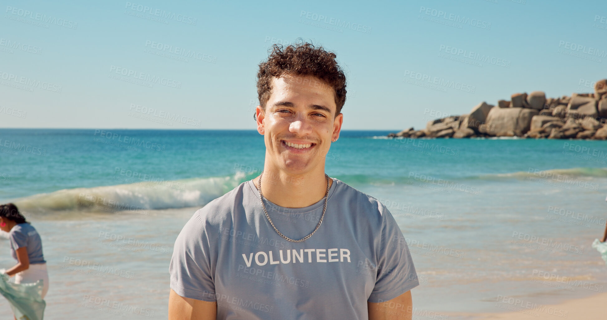 Buy stock photo Happy, man and portrait of volunteer on beach with confidence for social responsibility. Smile, NGO and male charity worker by ocean for community service with earth day project by sea conservation.