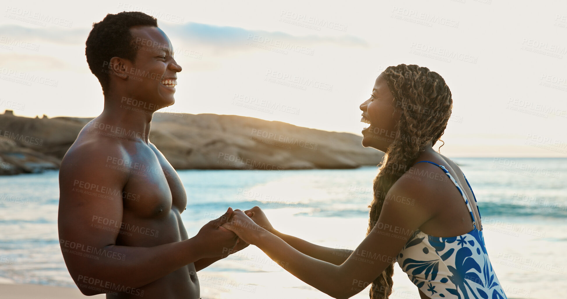 Buy stock photo Holding hands, laughing and love with black couple on beach together for bonding or dating. Funny, romance and sunset with happy African people outdoor in nature for holiday, travel or vacation