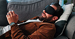 Man, sleeping and sofa for therapy session in office with hypnotherapy, guidance and technique. Male person, sleep mask and counseling with sensory awareness, healing subconscious and rehabilitation