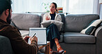 Woman, therapist and writing with patient for counseling, rehabilitation or therapy session on sofa. Female person, client and speaking with counselor or psychologist for help or advice in office