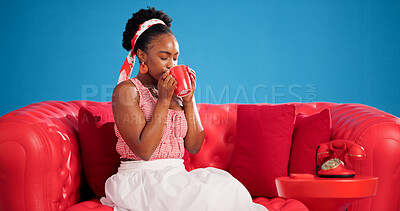 Buy stock photo Coffee, relax and studio with black woman on sofa for me time chilling, satisfaction or unwind. Break, cup and sip with African person drinking beverage on blue background for weekend wellness