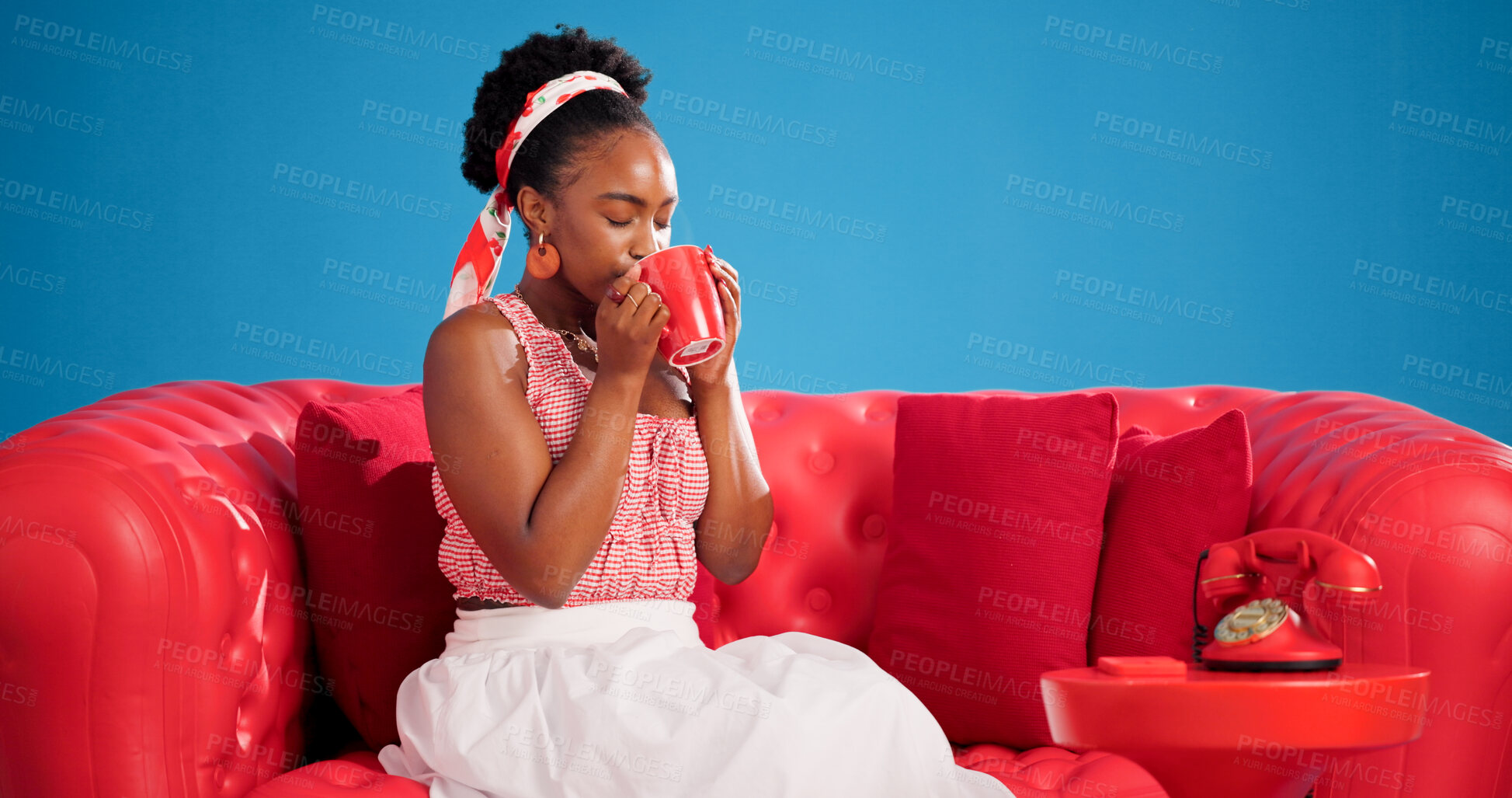 Buy stock photo Coffee, relax and studio with black woman on sofa for me time chilling, satisfaction or unwind. Break, cup and sip with African person drinking beverage on blue background for weekend wellness
