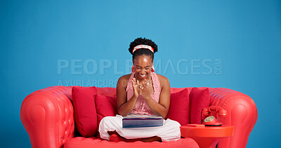 Buy stock photo Funny, surprise and tablet with black woman on sofa for reaction to social media post. App, applause and studio with excited African person laughing on blue background for celebration or good news