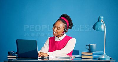Buy stock photo Laptop, smile and typing with black woman in call center for consulting, feedback or support. Computer, headset and studio with happy African agent on blue background for customer service or review