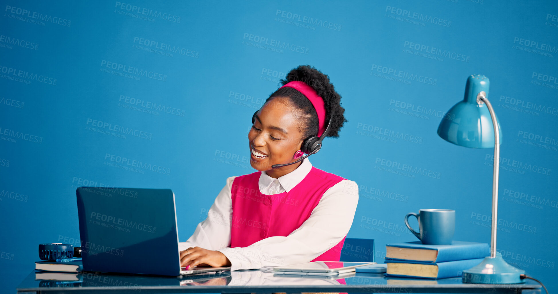 Buy stock photo Laptop, smile and typing with black woman in call center for consulting, feedback or support. Computer, headset and studio with happy African agent on blue background for customer service or review