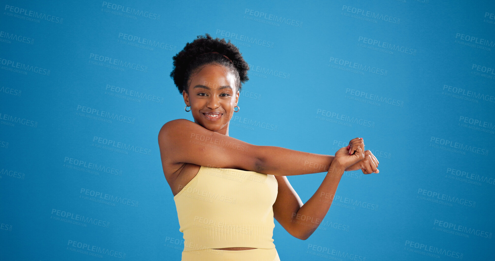 Buy stock photo Portrait, stretching or black woman in studio for fitness, warm up routine or arm muscle relief activity. Start, happy athlete or workout preparation for wellness, mockup space or blue background