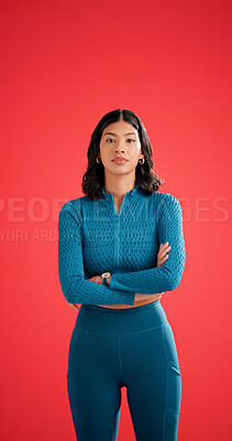 Buy stock photo Portrait, athlete and woman with arms crossed in studio, serious and pride for fitness with workout. Red background, wellness and person with confidence on space, strong and body care in Colombia