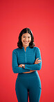 Happy, athlete and woman with arms crossed in studio, portrait or confident for fitness with workout. Red background, wellness and healthy person with smile on space, strong and body care in Colombia