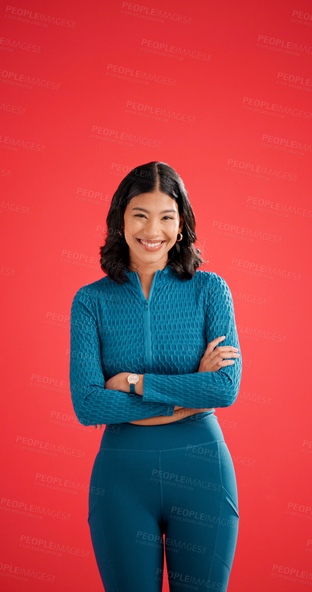 Buy stock photo Happy, athlete and woman with arms crossed in studio, portrait or confident for fitness with workout. Red background, wellness and healthy person with smile on space, strong and body care in Colombia