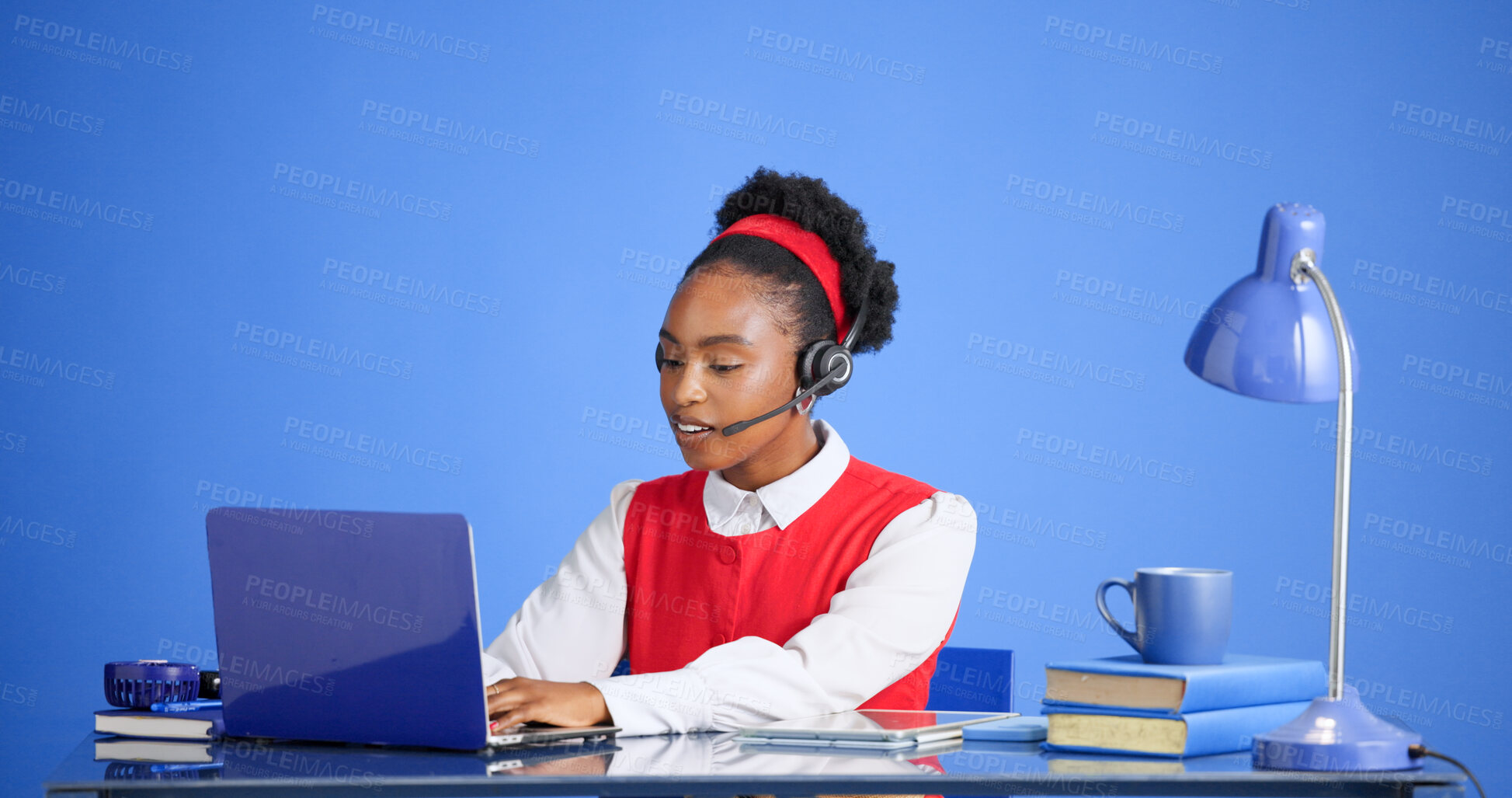 Buy stock photo Headset, laptop and typing with black woman in call center for consulting, feedback or support. Computer, report ad studio with African agent on blue background for customer service or review