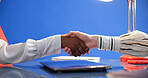 Shaking hands, deal and thanks for interview in studio, space and onboarding on blue background. Business people, handshake and recruitment with success, congratulations and agreement at hr agency