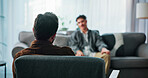Talking, sofa and therapist with patient in office for advice, help or life coaching session. Mental health, consulting and psychologist with man for emotional support, wellness or conversation.