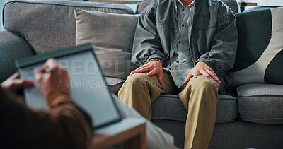 Buy stock photo Hands, anxiety and man on sofa by psychologist for emotional support, help or advice on mental health. Nervous, notes and person with life coach for therapy, wellness or counseling session at clinic.