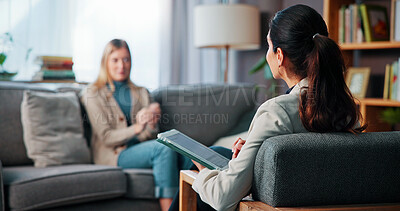 Buy stock photo Consultation, therapy and woman with anxiety, stress and tablet for recovery and mental health in clinic. Counselor, psychologist and patient on sofa for trauma, diagnosis or conversation for help