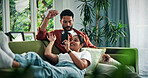 Happy couple, relax and sofa with phone for social media, network or sharing news in home. Man, woman or lying with smile on living room couch for holiday app, weekend or bonding together in house