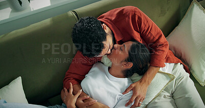 Buy stock photo Love, couple and relax with kiss on sofa for bonding together, romance and healthy relationship. Above, people and hug with affection in home for connection, loyalty and marriage security with trust