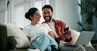 Buy stock photo Laugh, talking and couple on sofa with tech for social media, networking and bonding on weekend. Marriage, relax and man with woman on phone and laptop for internet, website and connection in home