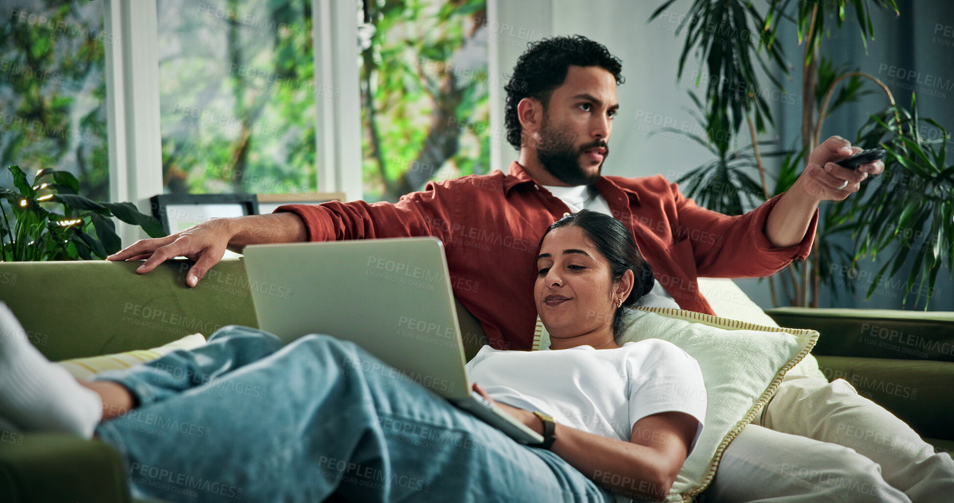Buy stock photo Couple, relax and watching tv with laptop on sofa for online entertainment together in home. Man, woman or subscription with computer, remote or channel on couch for app, movie or news in house