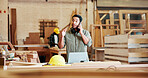 Phone call, carpentry and man in workshop with argument for late delivery of materials for project. Cellphone, industry and woodworker on mobile discussion with conflict for manufacturing furniture.