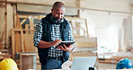 Black man, carpenter and typing with tablet at factory, notes and manufacturing report at industrial plant. Mature person, technician and scroll on app for review, material or production at warehouse