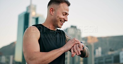 Buy stock photo Fitness, smile and watch with man in city for progress, training or workout tracking as runner. Buildings, exercise and time with happy athlete outdoor in urban town for health or wellness activity