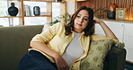 Thinking, relax and woman on sofa in home for reflection, nostalgia and daydreaming on weekend. Apartment, bored and person on couch with memory, thoughtful and wondering for planning day on break