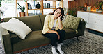 Thinking, bored and woman on sofa in home for reflection, nostalgia and daydreaming on weekend. Apartment, remember and person on couch with memory, thoughtful and wondering for planning day on break