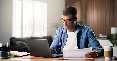 Buy stock photo Documents, laptop and remote work with man in home study for planning, research or review. Computer, paperwork and report with freelance employee at desk in apartment for small business startup