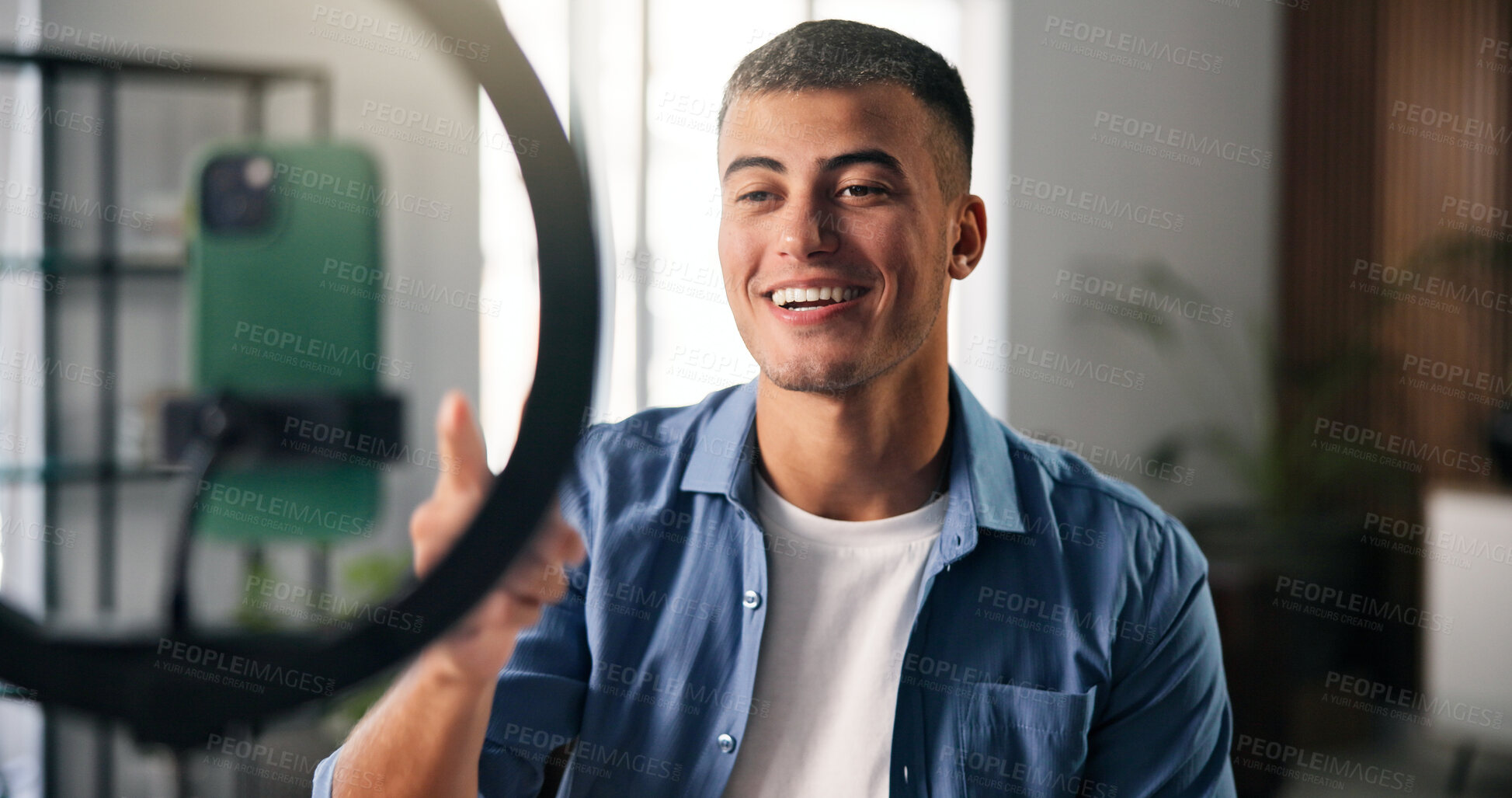 Buy stock photo Happy man, influencer and chat with ring light in house for content creation, smile and video on phone. Person, point and live streaming on web, mobile app and post on social network at apartment