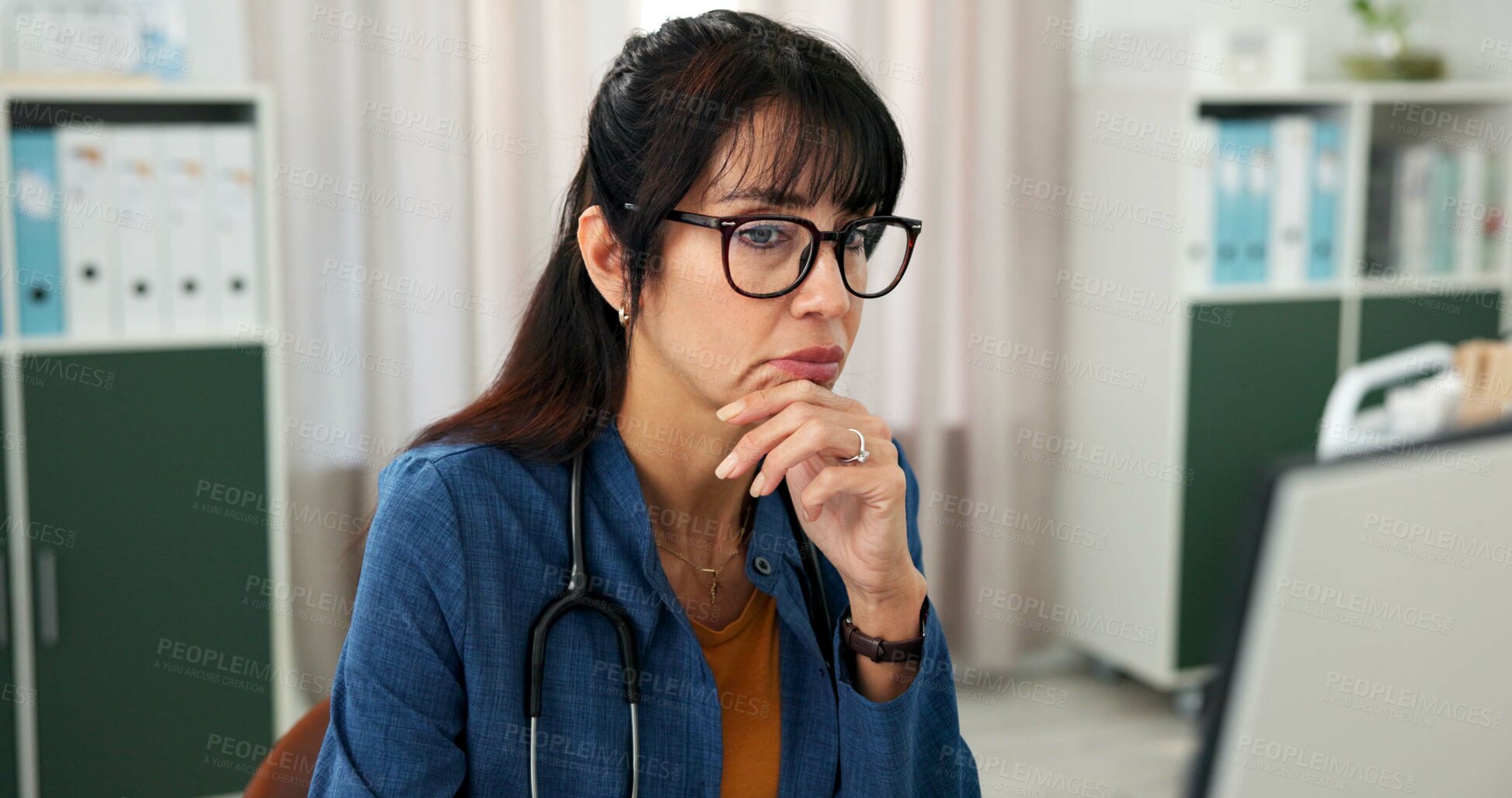 Buy stock photo Computer, doctor and woman in clinic with reading for patient review, medical research or diagnosis. Healthcare, office and mature person with digital tech, report or online reflection for telehealth
