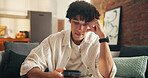 Man, thinking and research with phone on sofa for online menu, option or choice in home. Thoughtful, male person or scrolling with mobile smartphone for web service, decision or app on couch in house