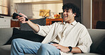 Watching tv, relax or man on couch with remote, series or sports broadcast on weekend break. Chill, movie binge and person in house with tech, multimedia streaming and subscription in free time.