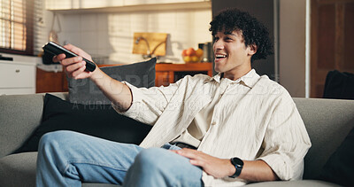 Buy stock photo Watching tv, relax or man on couch with remote, series or sports broadcast on weekend break. Chill, movie binge and person in house with tech, multimedia streaming and subscription in free time.