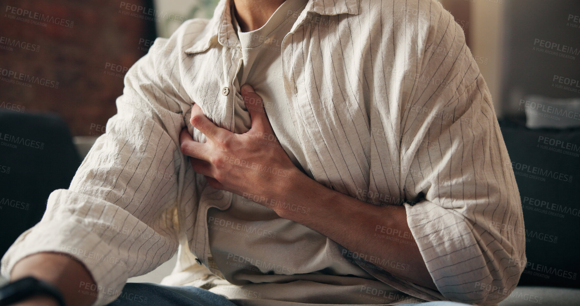 Buy stock photo Man, hands and sick in home with chest pain, heart attack symptoms or discomfort for medical problem. Person, cardiac arrest and health issue in house with disease, illness and emergency in lounge.