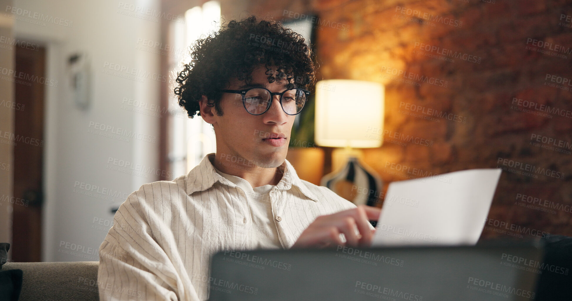 Buy stock photo Document, reading and man in home for remote work, accounting budget or audit report. Paperwork, person and freelancer in house to review revenue for income taxes, bookkeeping or financial info
