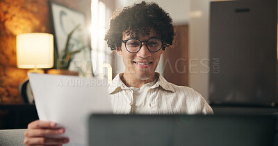 Buy stock photo Man, document and laptop in house with remote work, glasses and journalist verification for story. Freelance writer, person and proofreading in home with computer, paperwork or smile for article idea